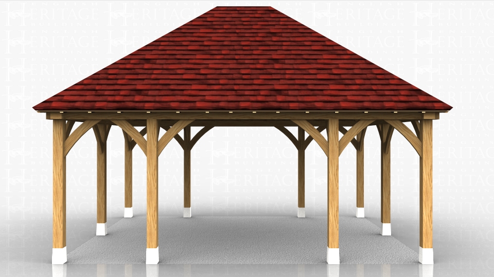 Open sided oak shelter used as a shaded sitting area in a garden.