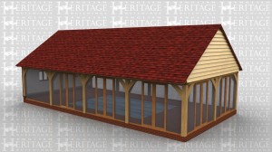 This 4 bay swimming pool enclosure has glass on three sides with five sets of glazed doors that would lead out onto a large paved patio area.