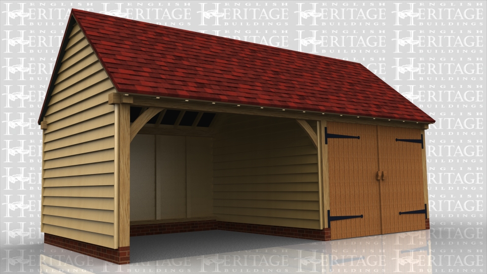 This oak framed garage building has two bays; one bay is open and one is enclosed. The enclosed bay is accessed via a set of garage doors to the front of the building.