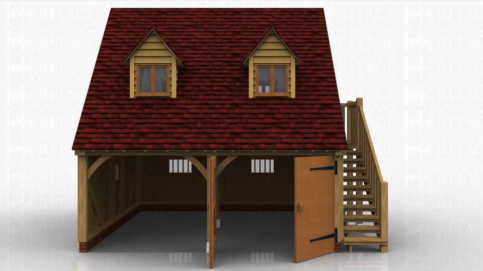 This is a two bay oak framed garage with room above. The ground floor has 2 garage bays, one open fronted and the other enclosed by a partition and a pair of garage doors. There are 3 mullion windows in the garage areas. There is an external oak staircase leading to a half glazed single door which accesses the first floor. There are 4 dormer windows suitable for two pane casement windows and a 3 pane escape casement window in the gable end.