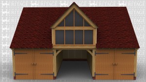 A three bay garage with the end bays secured with garage doors and front to rear partitions. The first floor is accessed through a half glazed single door in the right hand end. This is easily accessed as the building is built close to a 2m high retaining wall and the house is on the higher area. There is a full bay dormer which is fully glazed to take advantage of the magnificent views from this location.