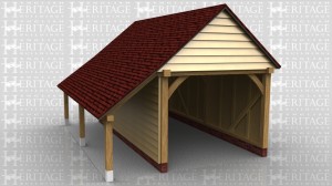A single bay garage with gable ends and a log store to the left hand side.