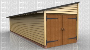 This is a long one bay monopitch garage with garage doors at one end. All other walls are clad in softwood weatherboard and the roof has a slate finish.