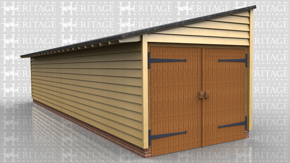 This is a long one bay monopitch garage with garage doors at one end. All other walls are clad in softwood weatherboard and the roof has a slate finish.