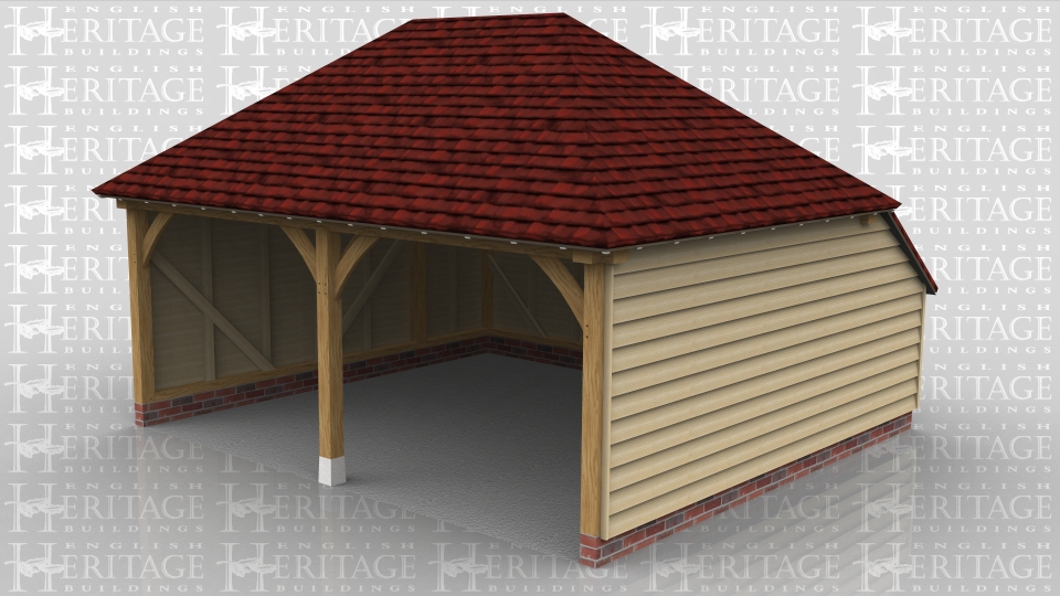 This two bay open fronted oak frame garage has hipped roof ends and an enclosed rear logstore to keep the ridge height below 4m and still give a usable internal depth.