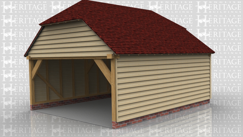 This oak framed building is a wide garage with two enclosed bays. Access is via an open left side and a single half glazed door on the right side.