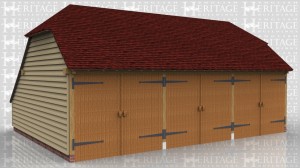 This is a three bay oak framed garage with hipped ends and an enclosed store to the rear. All three bays are enclosed and accessed via three sets of garage doors to the front.