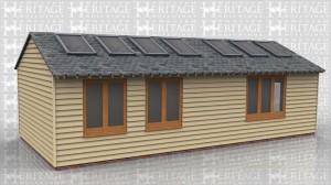 This oak frame is an artist's studio and workshop. There are large rooflights and windows along the back to get as much natural light inside as possible. The building is split into two with a partition that has a pair of half glazed doors in it. One side is for drawing and painting and the other side is for pottery and has a kiln in one corner. The roof has gable ends and a low pitch slate roof to keep the ridge height under 4m.