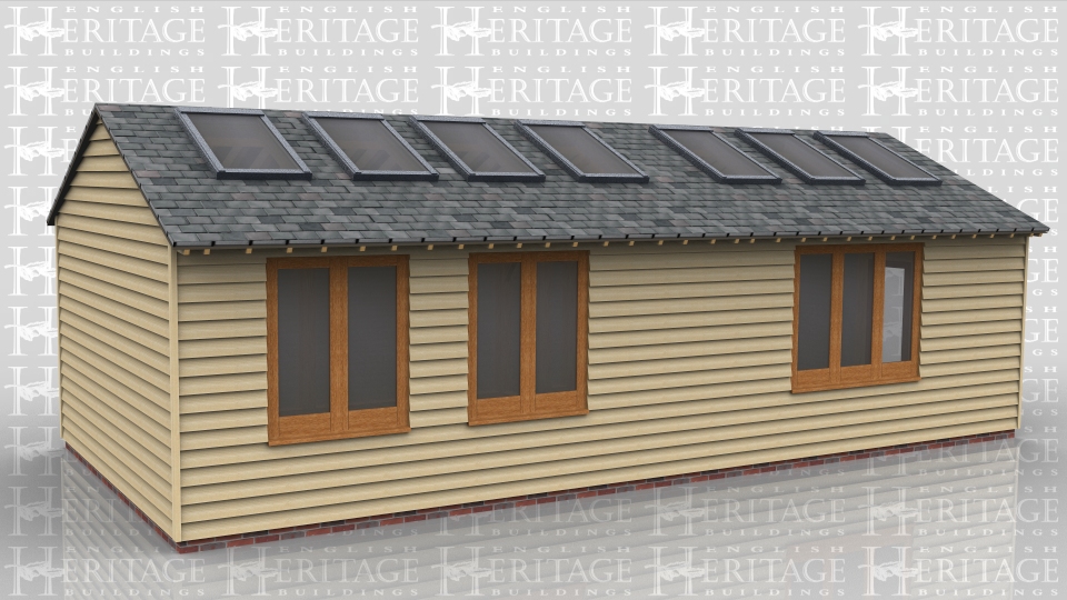 This oak frame is an artist's studio and workshop. There are large rooflights and windows along the back to get as much natural light inside as possible. The building is split into two with a partition that has a pair of half glazed doors in it. One side is for drawing and painting and the other side is for pottery and has a kiln in one corner. The roof has gable ends and a low pitch slate roof to keep the ridge height under 4m.