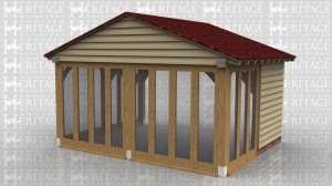 This oak framed garden room extension has a shallow pitched roof to avoid a first floor window. There is full bay glazing all around except one panel of weatherboard.