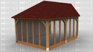 This oak framed home extension has one weatherboarded side and two sides with full length windows. The end of the frame is designed to be attached to an existing building.