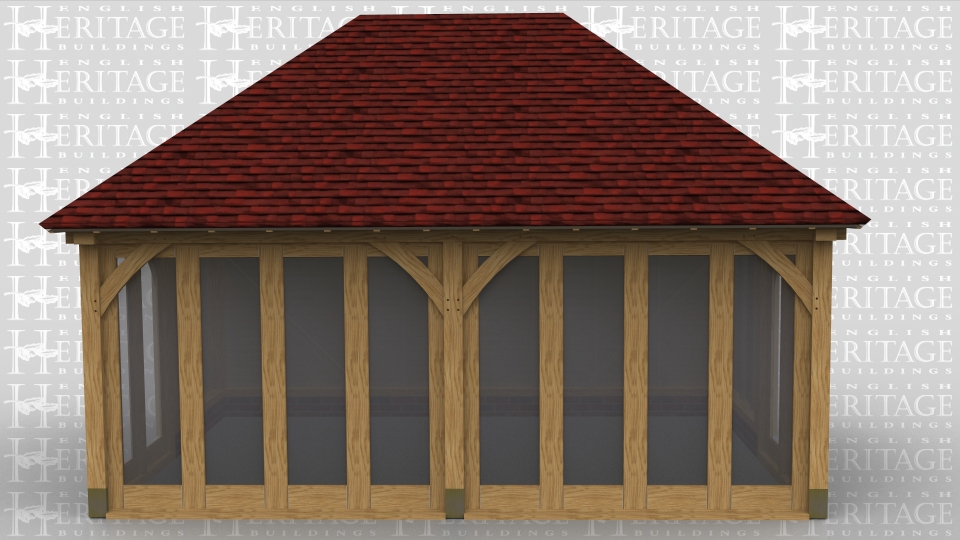 This oak framed garden room has full length windows along the front of the building and softwood boarding around the rest of the oak frame.