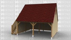 This is an oak framed building with an upper floor which is accessed via the external staircase on the left hand side. The two bays are open and there is a two pane window on the right hand side. There are trimmings for two rooflights on the front of the building to bring in more natural light to the upper floor.