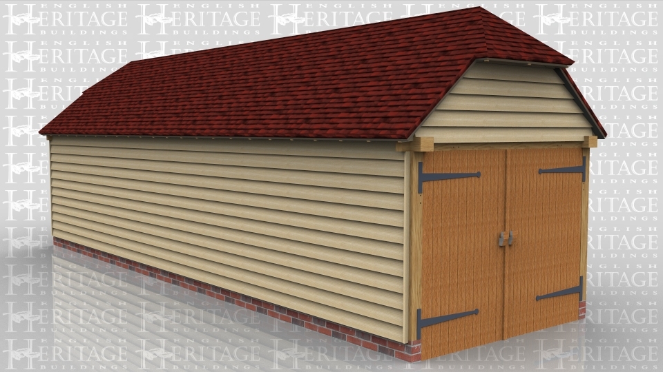 This is a one bay oak framed garage secured with a set of garage doors on each end. There is also a barn hip on each end.