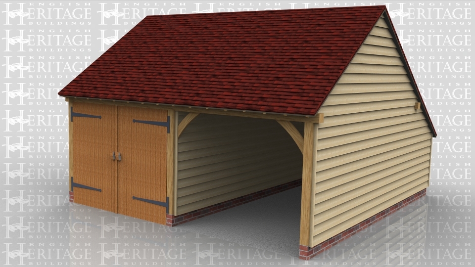 This is a two bay oak framed garage with on enclosed bay secured with a set of garage doors. There is also an enclosed store to the rear.