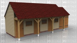 This oak framed building is comprised of two different frames. One is a three bay stable with each bay enclosed and accessed via a stable door to the front and a mullion window. The other frame is a single bay enclosed garage with standard garage doors to the front.
