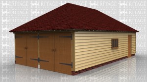 This oak framed garage building has a set of garage doors to the left hand side and a single solid door to the front. There are also three pane windows to the front and side.