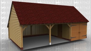 This oak framed three bay garage has two open bays and one enclosed. The enclosed bay is accessed via a garage door. To the rear there is an open store and a mullion window to the right hand side.
