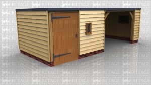 This oak framed building has a flat roof with one enclosed bay, designed to be used as a store or a workshop, and accessed via a single door to the front and with a window to the right of the door. The other two bays form one large open garage space, with a mullion window to the right hand side.