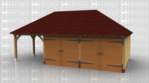 This oak framed garage building has one open bay on the left and two enclosed garage bays. The enclosed bays are accessed by a set of garage doors to the front.
