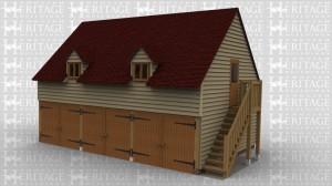 A two storey oak framed garage with 3 bays using a sling brace design. The lower floor is secured with garage doors and an external staircase leads to a studio upstairs which has two dormers with windows to front and rear.