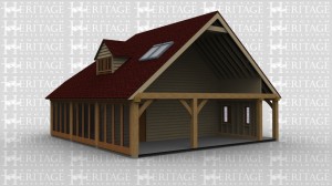 An oak framed house extention connecting to the existing building. The sides have full height glazing, a door, and in the high roof there is roof lighting and a dormer with a window.