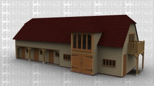 An oak framed two storey building. On the bottom floor both single and barn doors are used in this equestrian style building. On the first floor there is a balcony as well as roof lighting. Full height glazing is also used as well as sling brace in the framework.