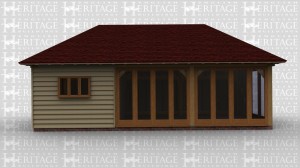 An oak garden room / summer house with some full height glazing and a workshop to one side.