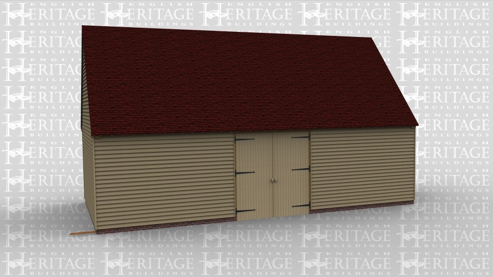 A large traditional oak frame barn building with one set of barn doors.