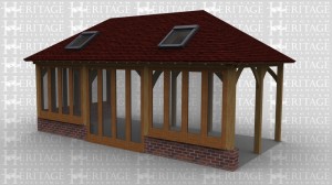 An oak frame home / garden room extension with full height glazing around 3 walls as well as fully glazed patio doors and 2 rooflights