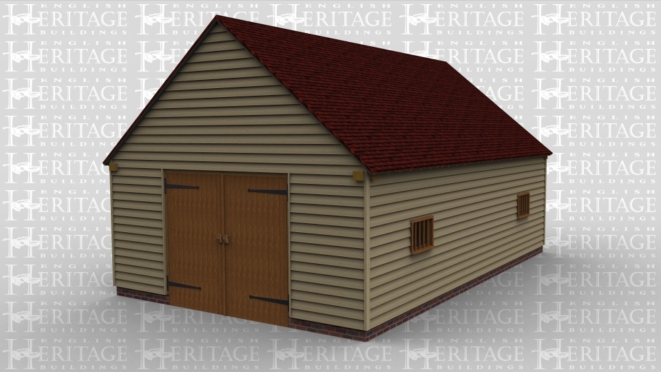 An oak frame garage / barn with large barn doors at the either end and two small windows on the side
