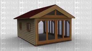 An oak frame home extension with full height glazing on 2 walls and on the thrid wall there are 2 smaller windows.