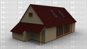 An oak framed leisure building with a front door and full hieght glazing down the front wall. On one side of the building is a logstore and on the other are barn doors. The roof of the building contains 2 large rooflights to allow the natural light to pour into the room.