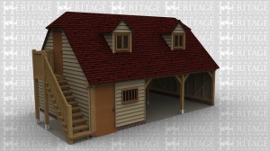 A oak frame garage with a parking bays and a workshop. As well as this there is an external staircase leading to the upper floor in which there is 2 dormer windows.