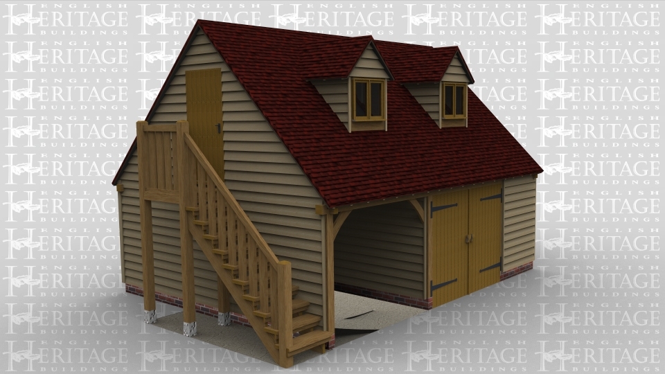 A 2 bay oak framed garage with upper floor. On the ground floor one bay is left open at the front while the second bay is enclosed with a pair of iroko garage doors. The left of the building has an external staircase leading to the first floor. On the first floor is a solid single door on the left of the building and at the front are 2 dormer windows housing a 2 light window in each.
