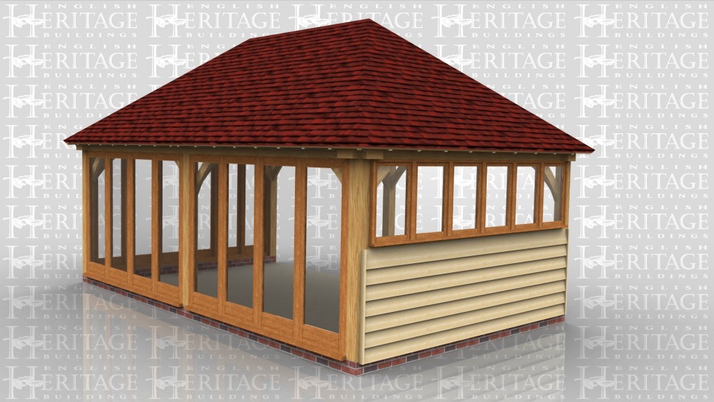 A 2 bay oak frame leisure building with a slate roof. There is a pair of iroko garage doors on the left wall as well as a logstore area beside it.