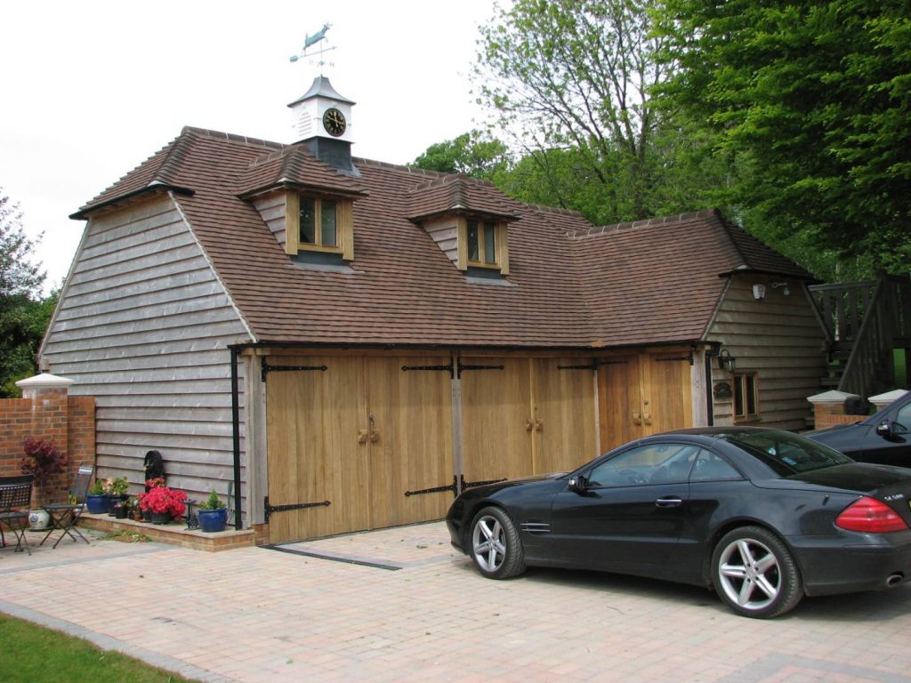 oak frame garage with car in driveway