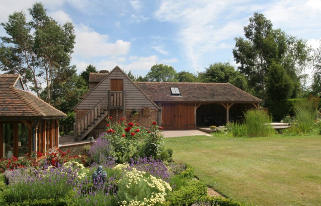wooden garage in back, flowers in front