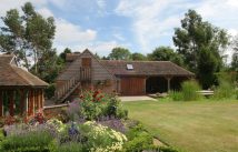 wooden garage in back, flowers in front