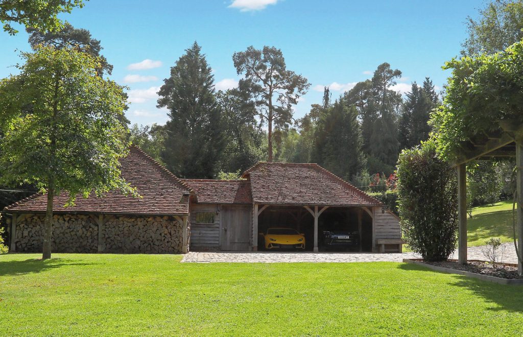 A garden building with a two bay garage on the side